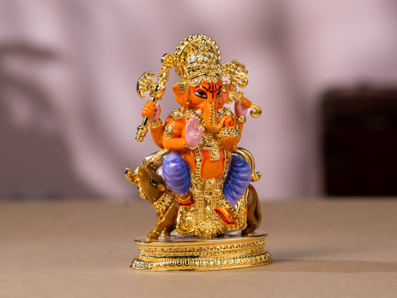 Handmade Enamel gold-plated Brass Ganesh Idol sitting with Mushak. Medium Statue.