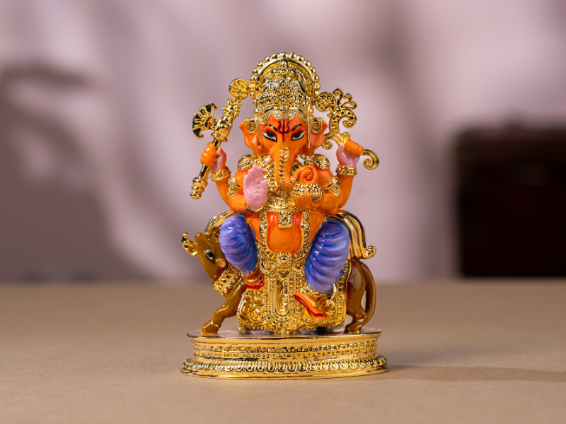 Handmade Enamel gold-plated Brass Ganesh Idol sitting with Mushak. Medium Statue.